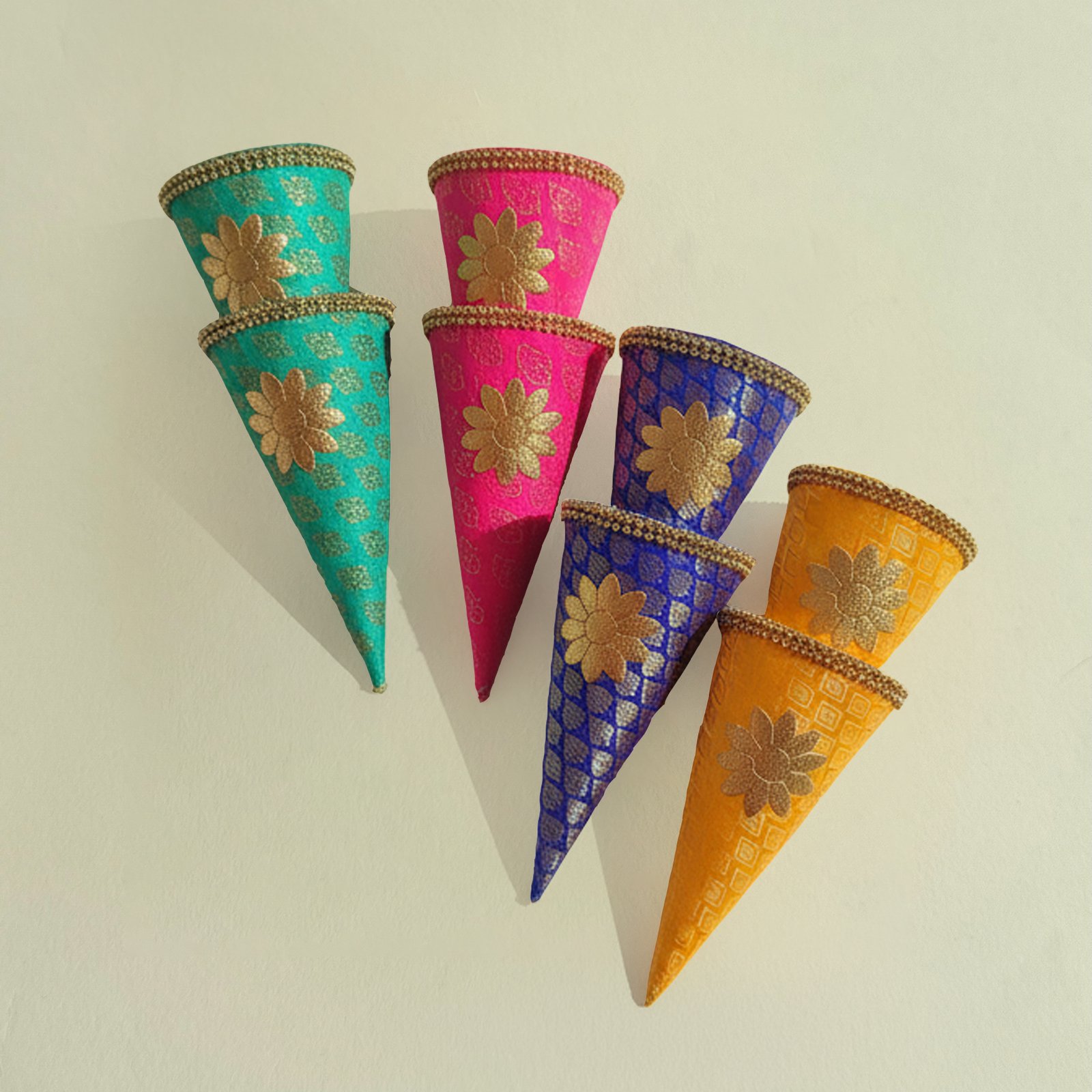 A vibrant collection of FS Jamawar Cones filled with traditional items for a desi wedding event. FS Jamawar Cones are the definitive solution for hosts and planners seeking to infuse their events with authentic royalty, vibrant colour, and functional beauty. They transform simple acts of gifting and decoration into profound cultural statements. Please Note: Due to the handcrafted nature of FS Jamawar Cones, all sales are final under our no refund, no exchange policy.