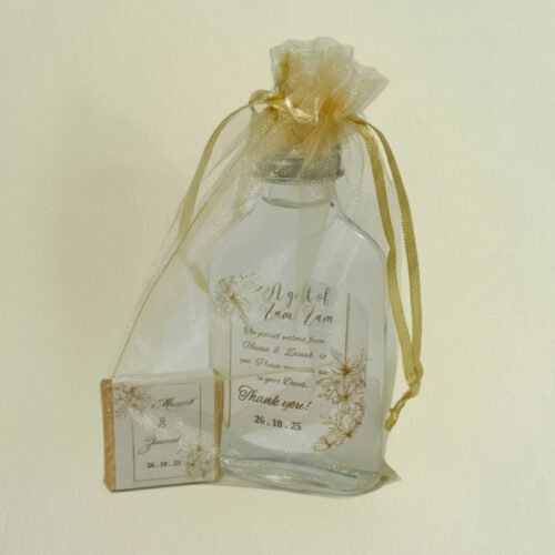 An elegant white Organza Pack for Mini Zam Zam Bottles by Favour Selebrations, tied with a golden ribbon